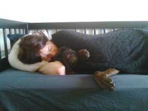 human_sleeping_on_a_bed_with_a_dog