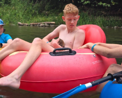 Teen Tubing Down River Reaches Into Water — And A Week-Old Baby Beaver Clings To Him