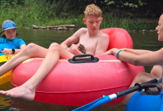 Teen Tubing Down River Reaches Into Water — And A Week-Old Baby Beaver Clings To Him